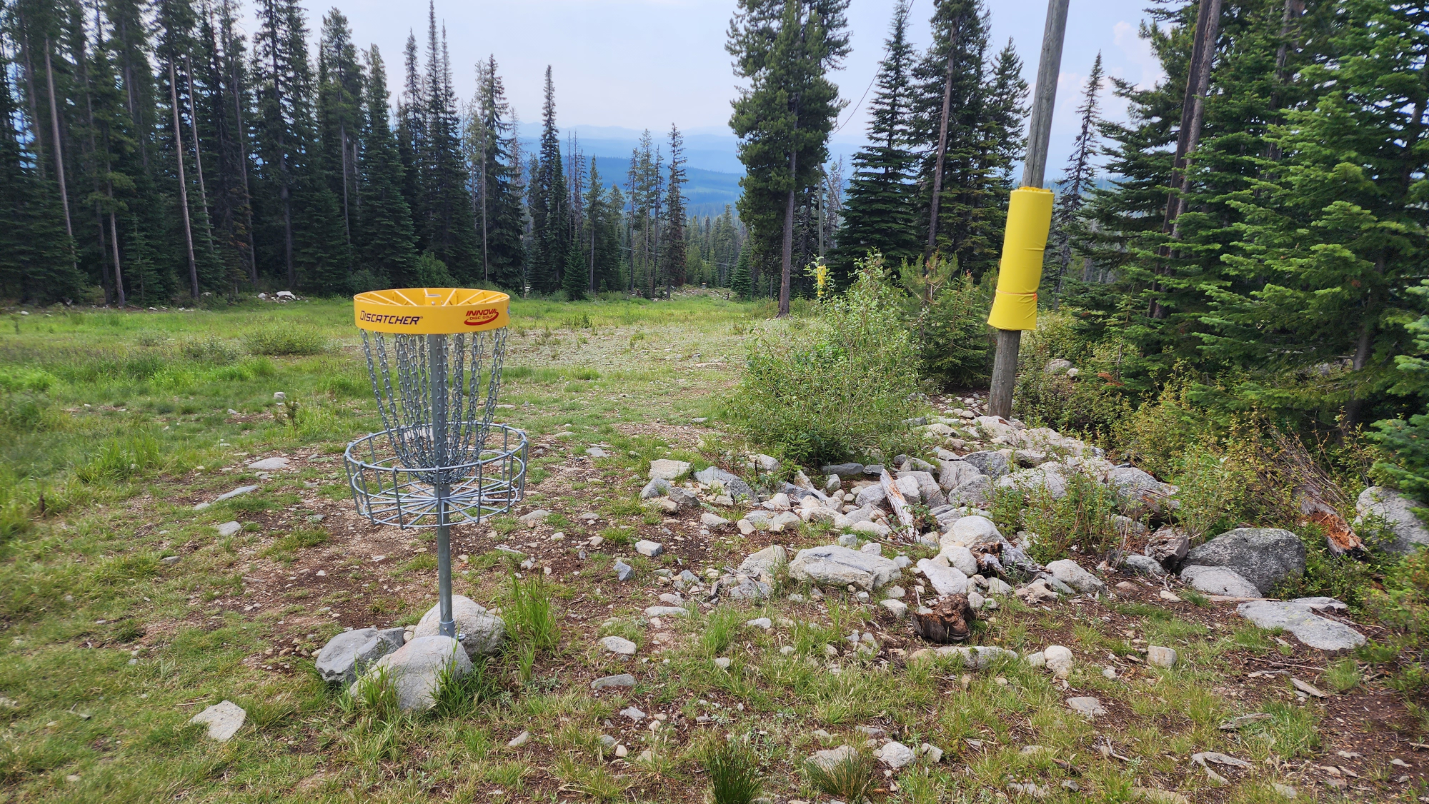 Mountain landscape with a disc golf basket silhouette